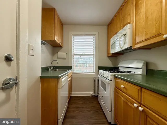 a kitchen with stainless steel appliances granite countertop a sink and a stove