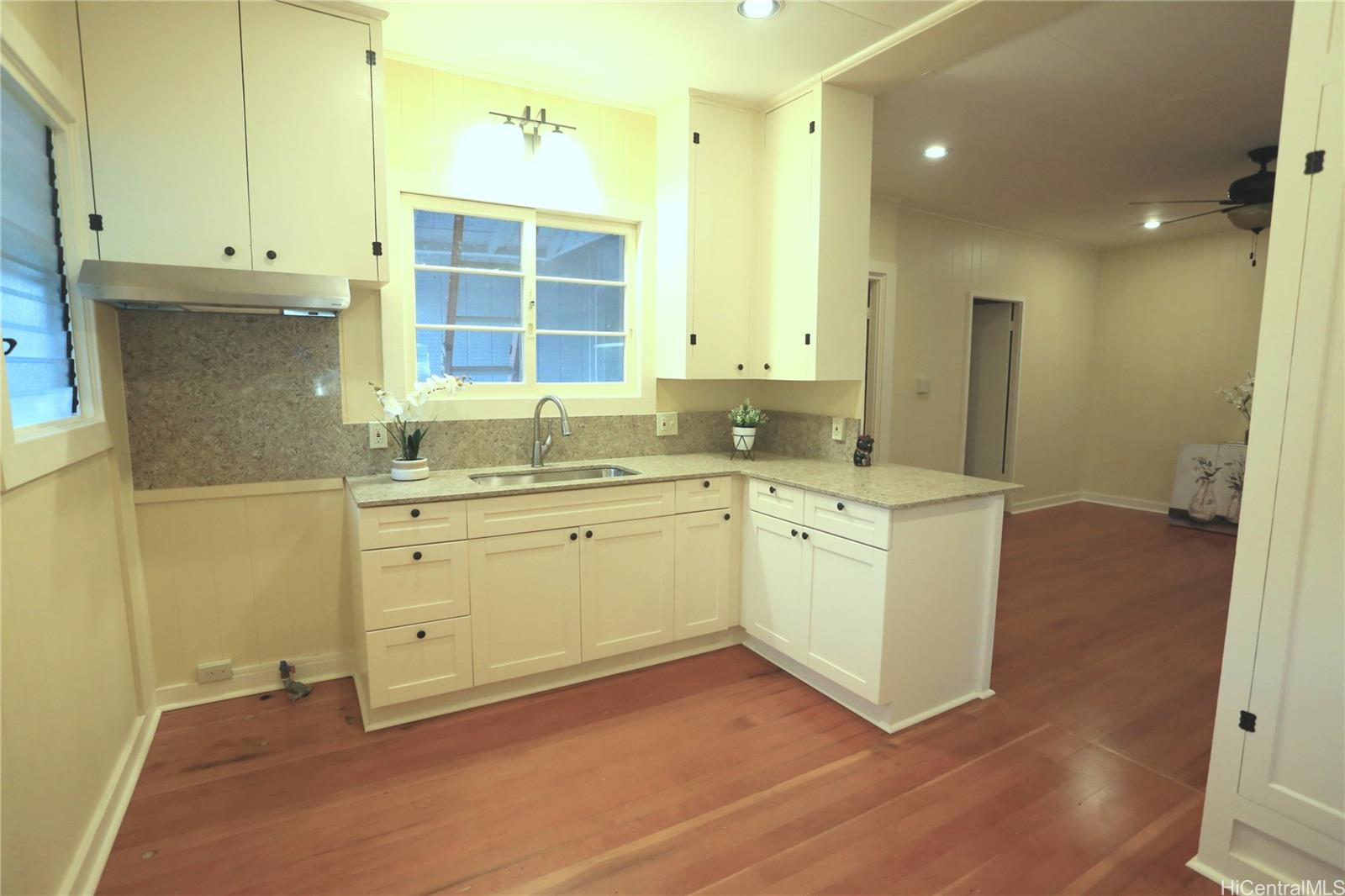 a view of a kitchen counter space and windows