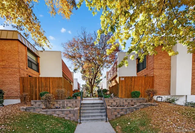 a front view of a house with a tree