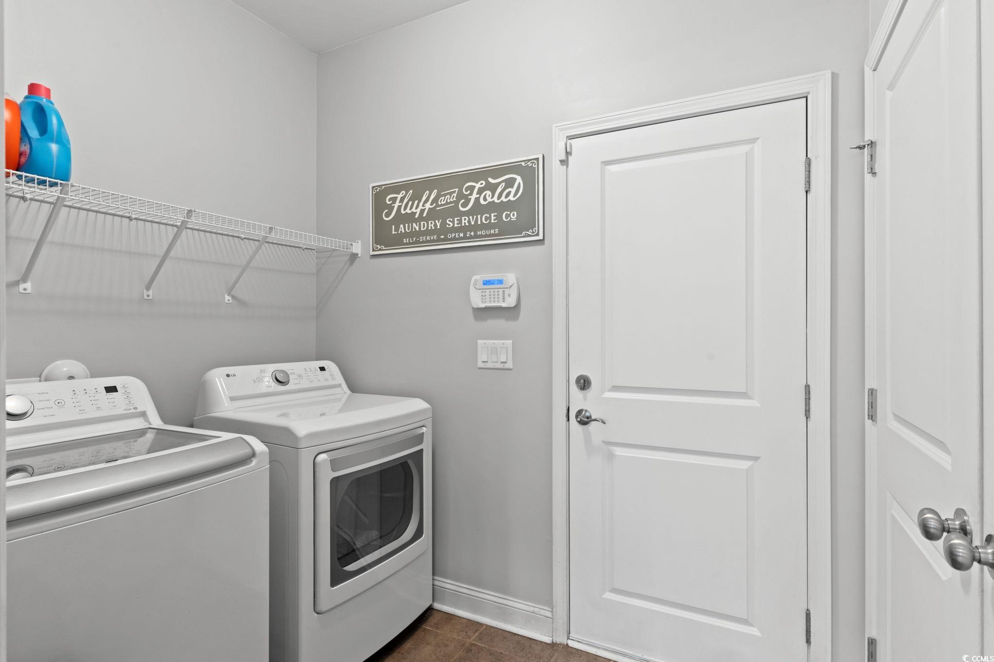 350 Long Meadow Drive Loris, SC 29569 - Photo 28 of 40 Laundry area featuring dark tile patterned floors and washing machine and clothes dryer