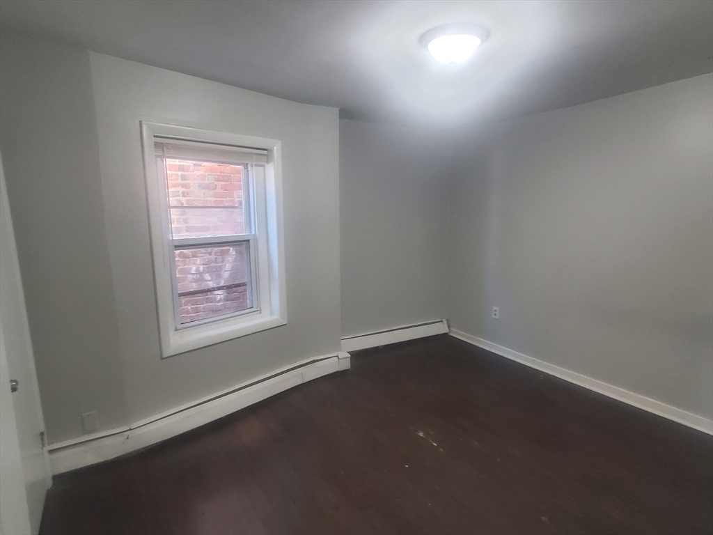 620 Dudley Street, Unit 4 Boston, MA 02125 - Photo 8 of 15 an empty room with a window