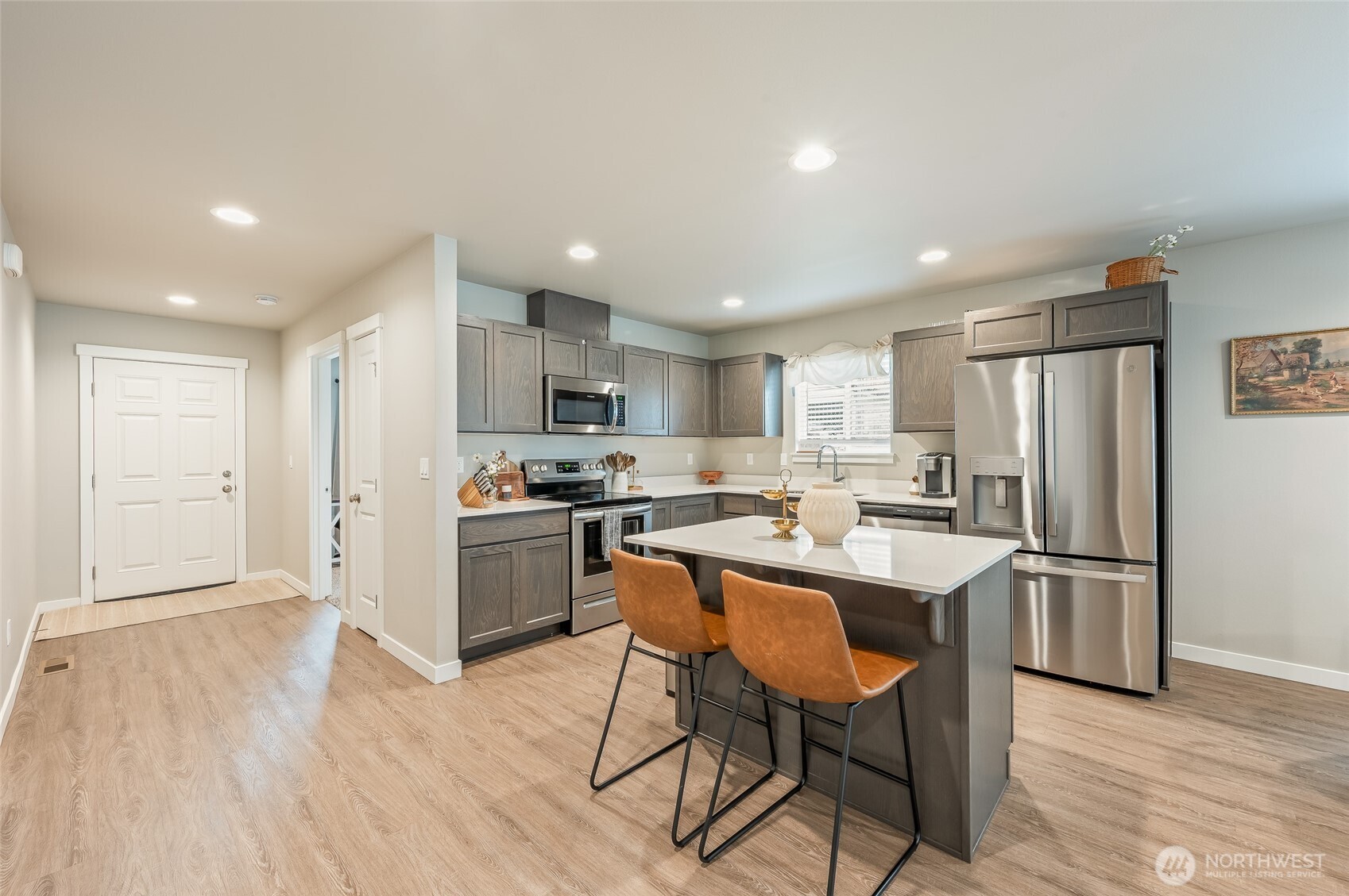 2205 Southeast Marlette Road East Wenatchee, WA 98802 - Photo 4 of 29 a kitchen with stainless steel appliances a refrigerator a stove a sink dishwasher with a dining table and chairs