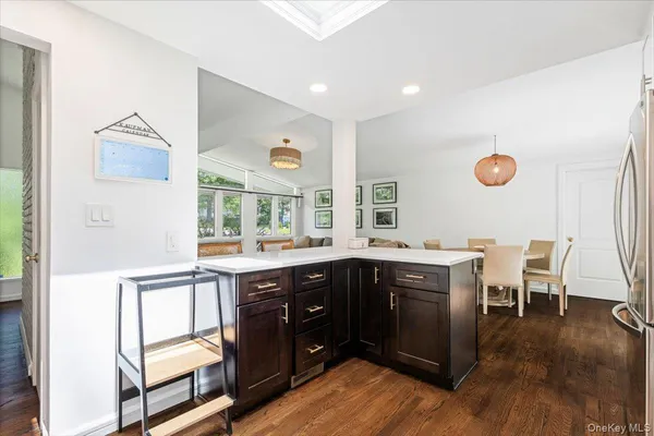 a kitchen with a sink appliances and wooden cabinets