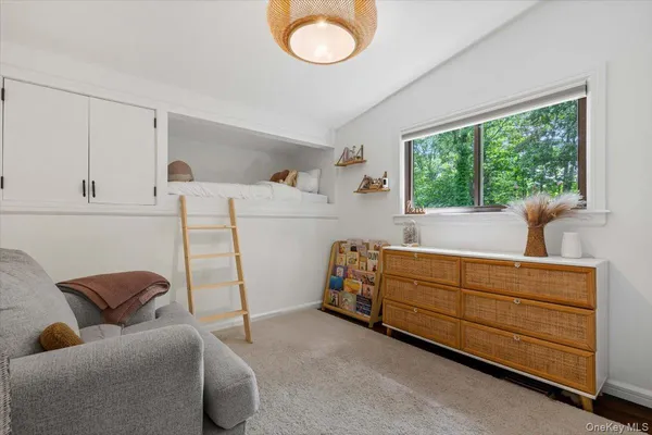 a bedroom with furniture and a window