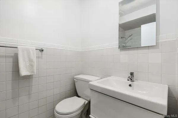 a white toilet sitting next to a white sink