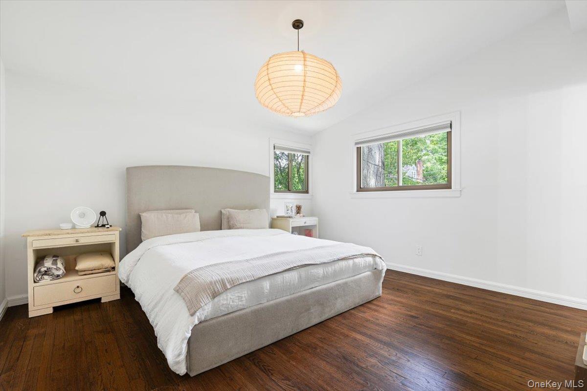 43 Winslow Road White Plains, NY 10606 - Photo 18 of 32 a bedroom with a bed and a chandelier