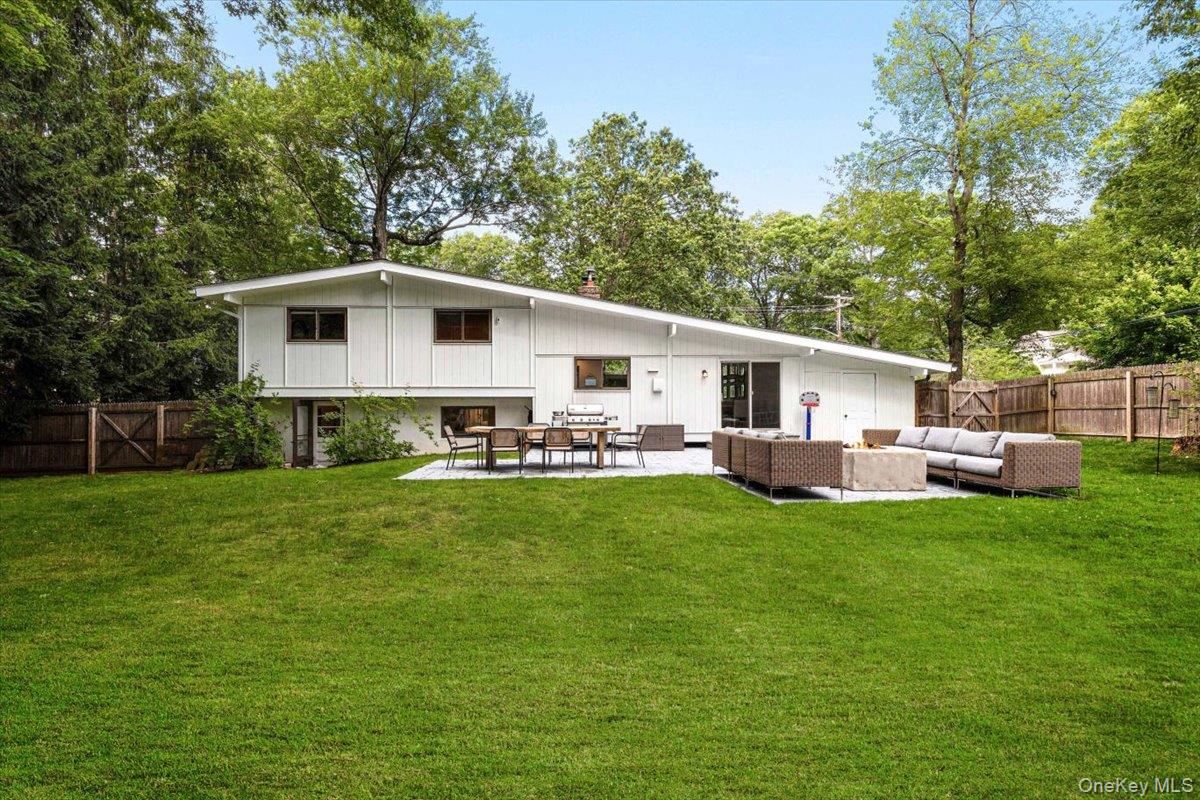 43 Winslow Road White Plains, NY 10606 - Photo 25 of 32 a white house that has a big yard with wooden fence