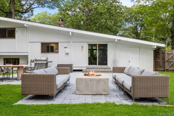 a outdoor living space with furniture and a fireplace
