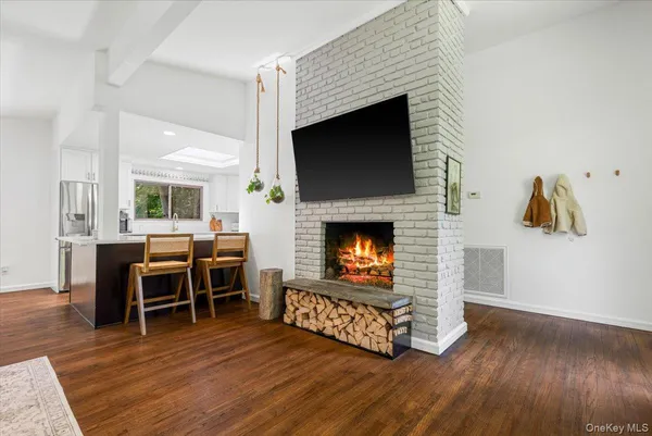 a living room with furniture wooden floor and a fireplace