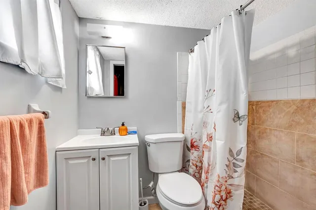 a bathroom with a sink toilet and shower