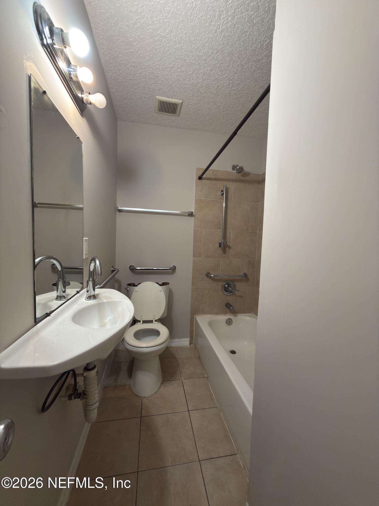 1709 Dot Street Jacksonville, FL 32209 - Photo 14 of 17 a bathroom with a sink a toilet and shower