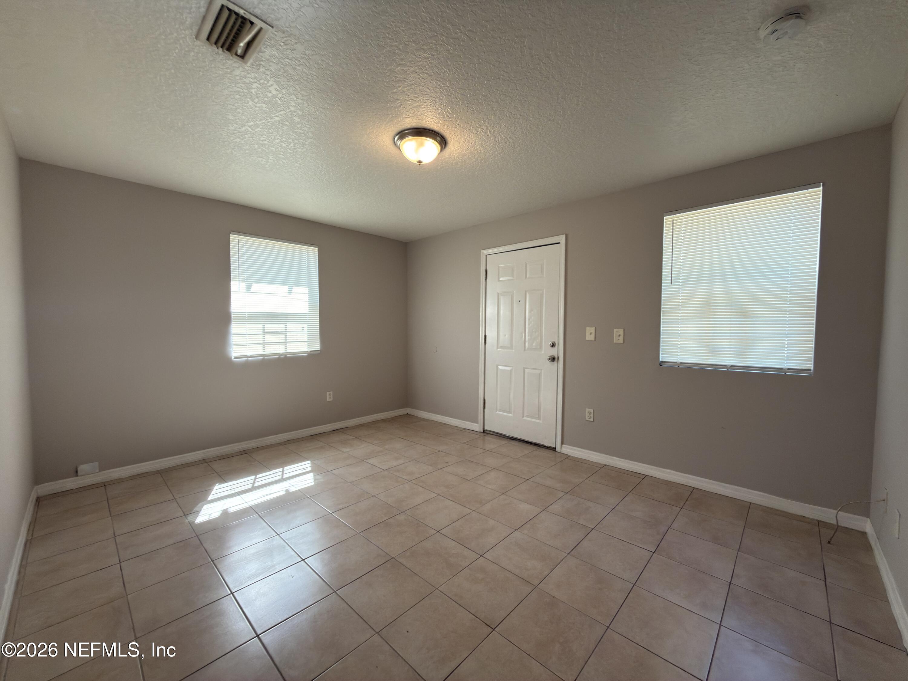 1709 Dot Street Jacksonville, FL 32209 - Photo 3 of 17 an empty room with windows