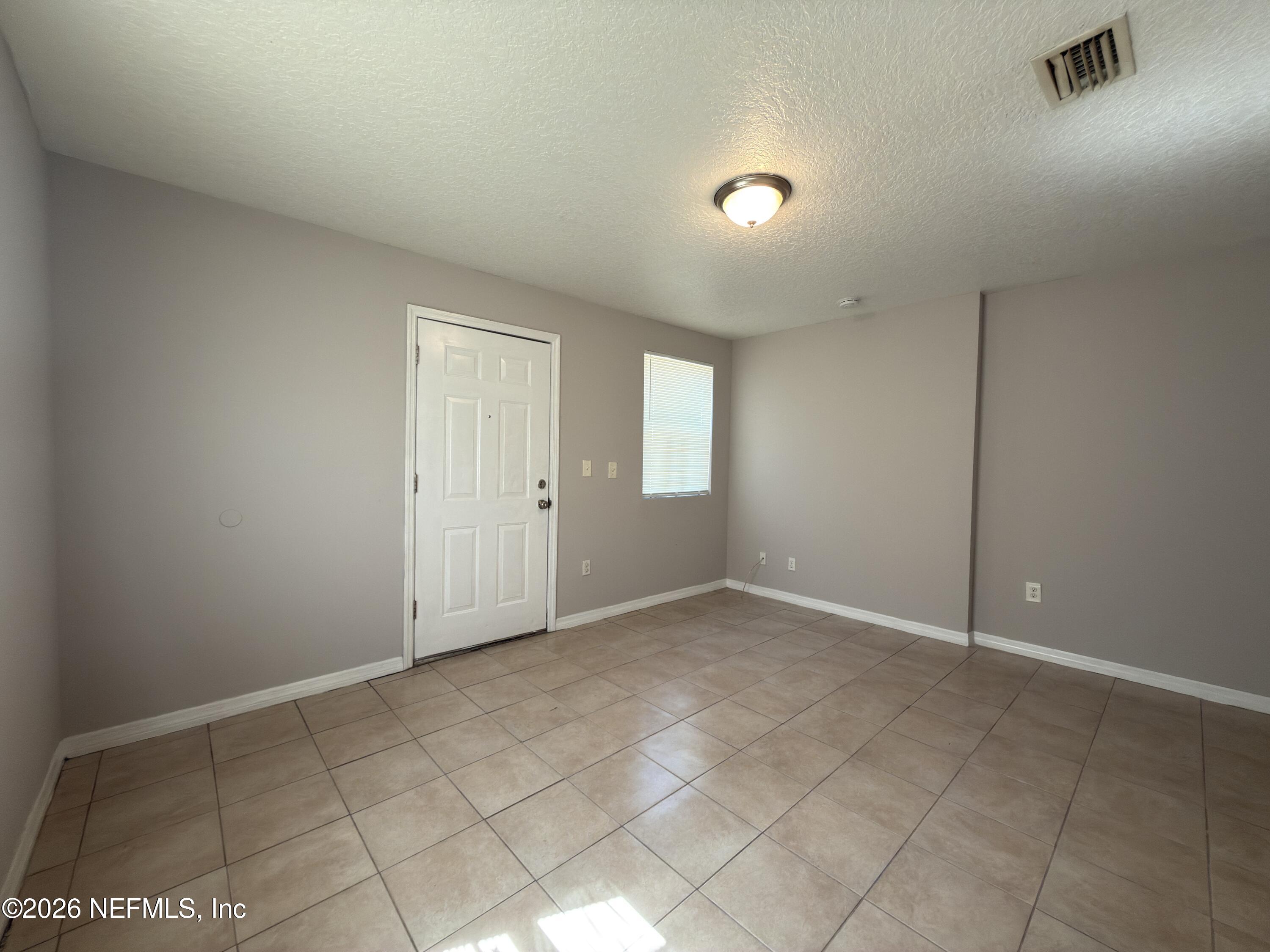 1709 Dot Street Jacksonville, FL 32209 - Photo 4 of 17 an empty room with windows and closet