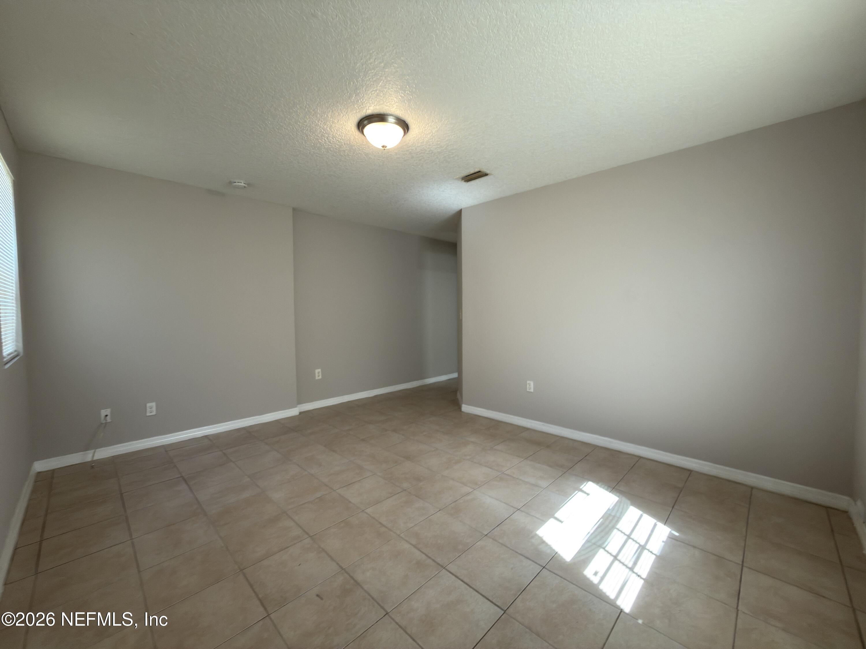 1709 Dot Street Jacksonville, FL 32209 - Photo 5 of 17 a view of an empty room and window