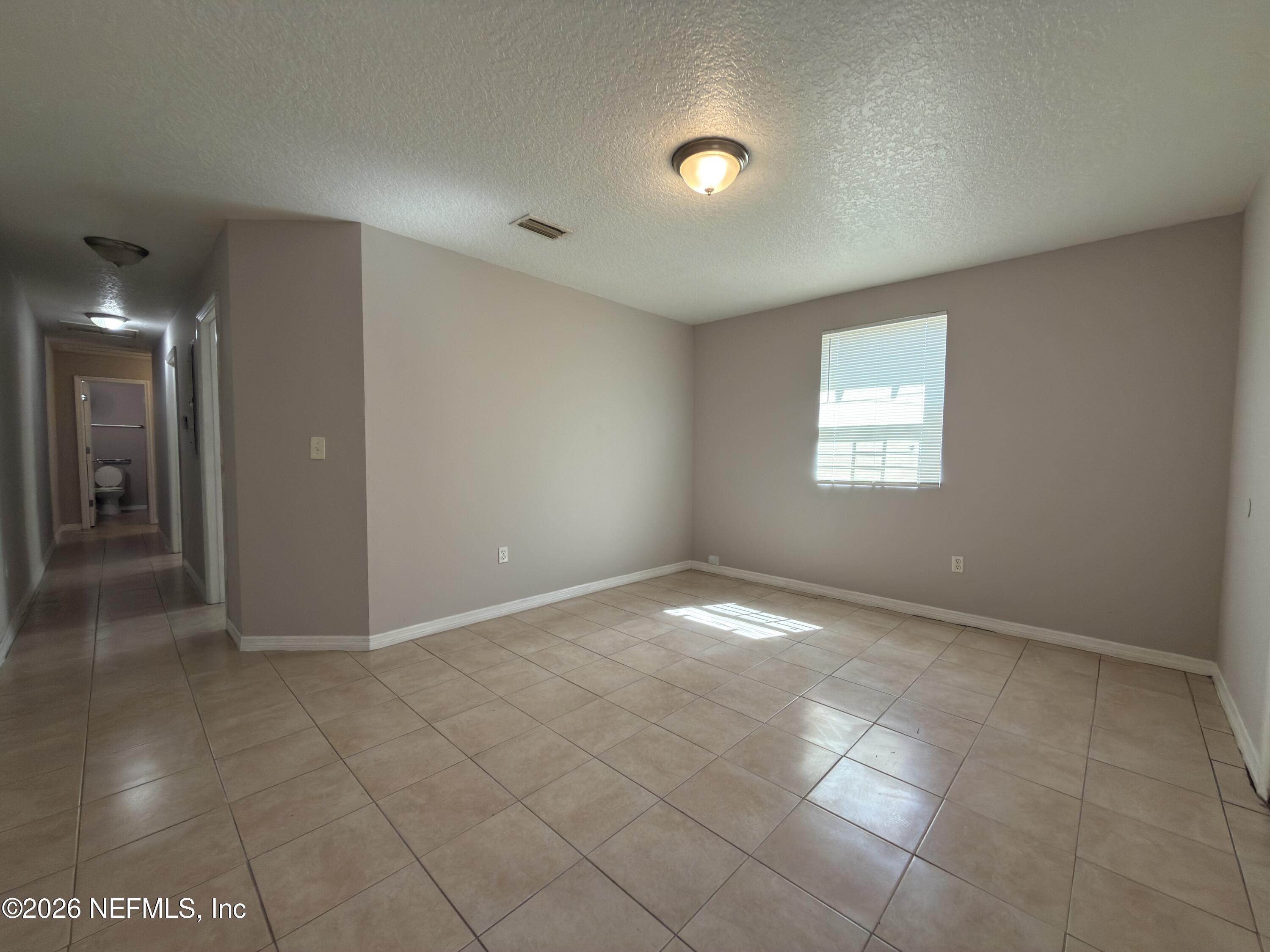 1709 Dot Street Jacksonville, FL 32209 - Photo 6 of 17 a view of an empty room with a window