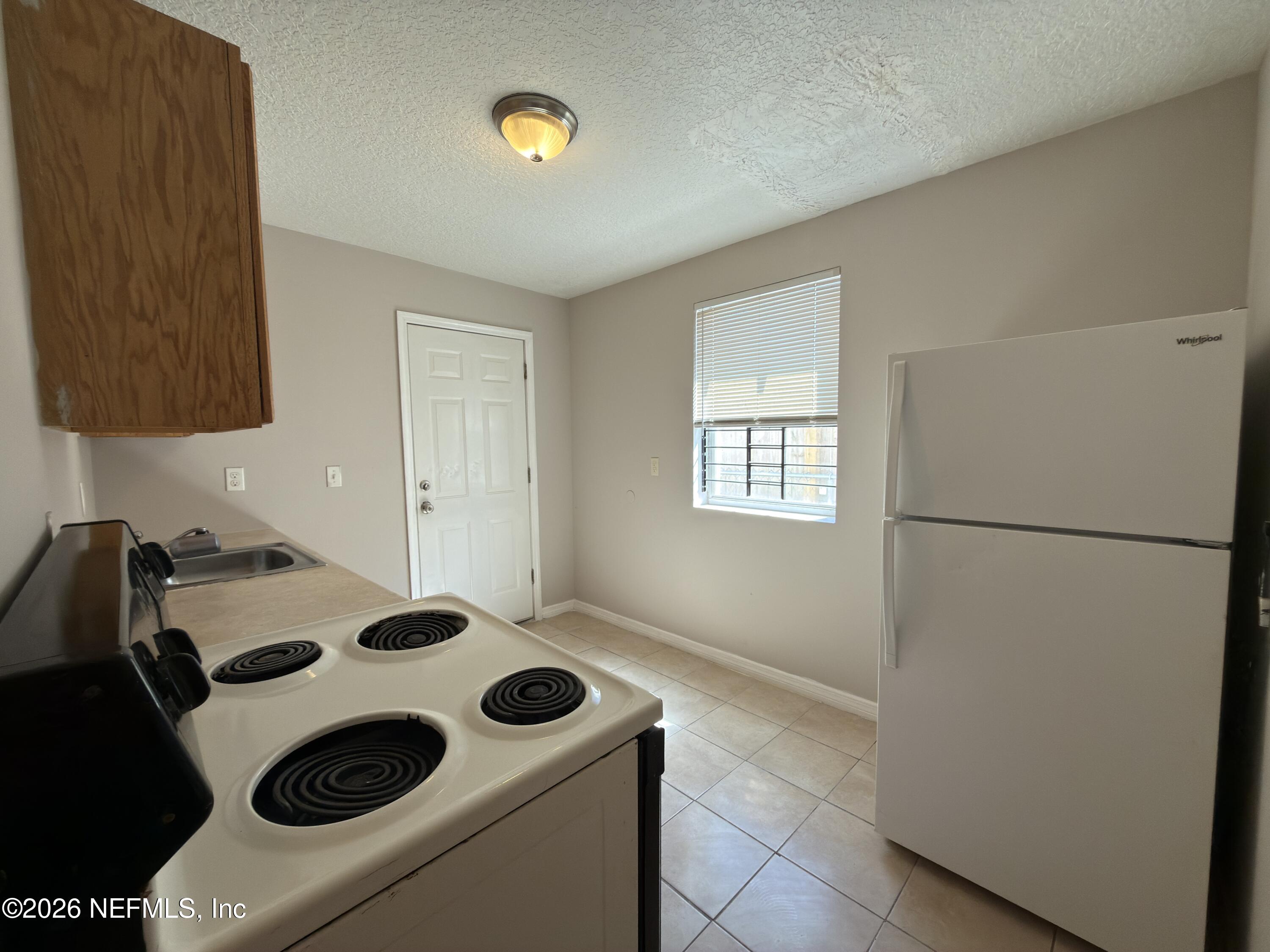 1709 Dot Street Jacksonville, FL 32209 - Photo 7 of 17 a kitchen with a refrigerator and a stove
