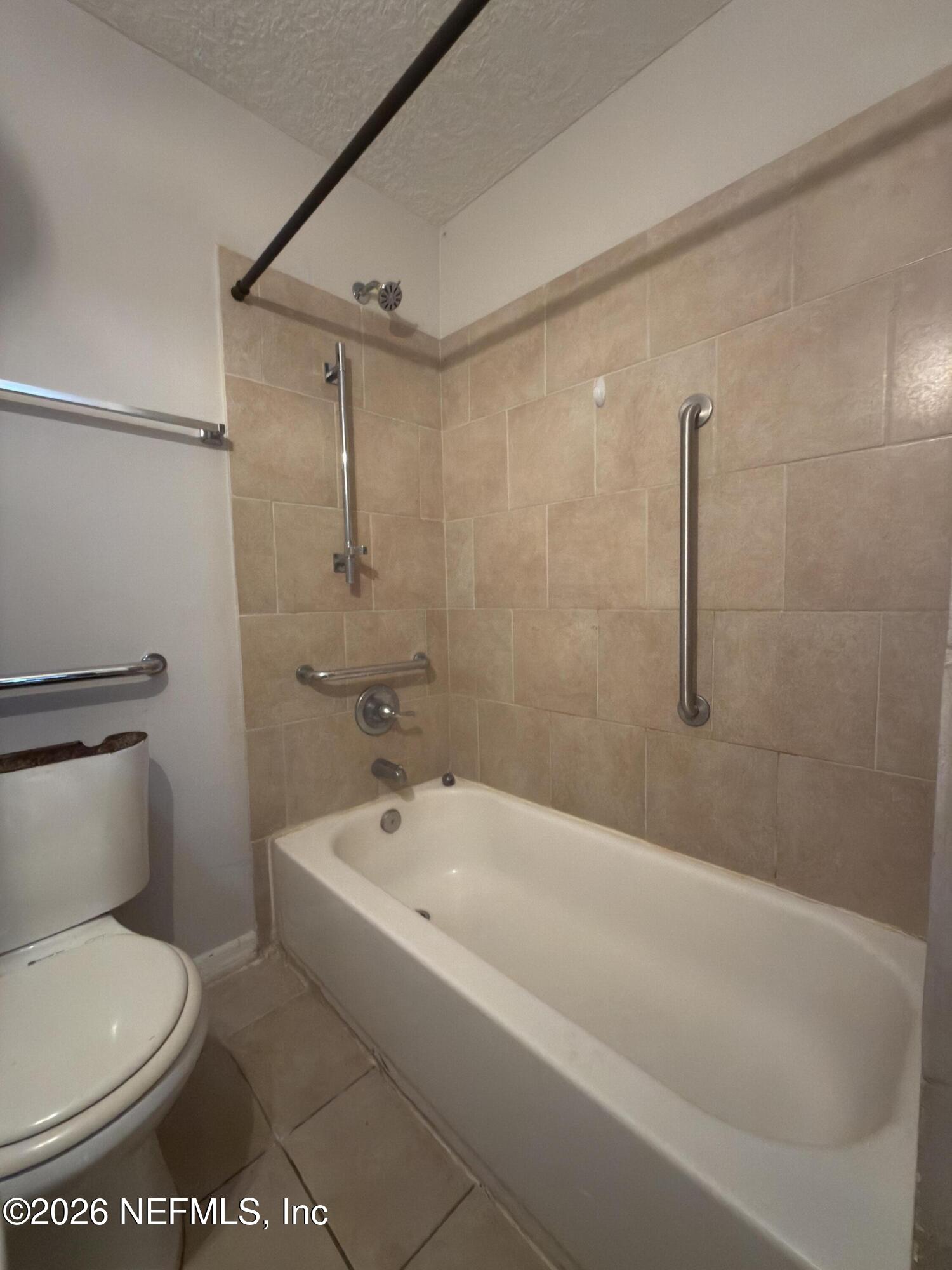 1709 Dot Street Jacksonville, FL 32209 - Photo 9 of 17 a white toilet sitting next to a bath tub