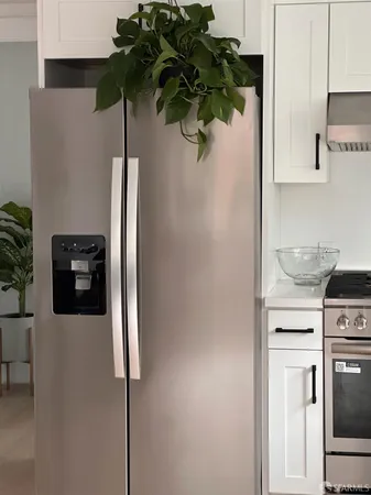 a kitchen with stainless steel appliances a refrigerator and a sink