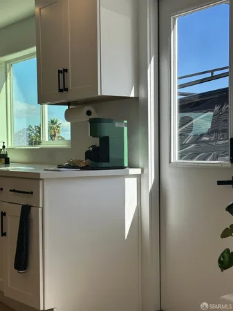 a kitchen with a refrigerator and cabinets