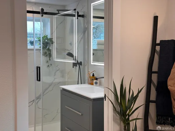 a bathroom with a shower and a sink