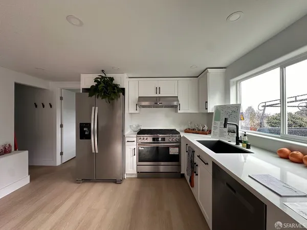 a kitchen with a sink appliances and window