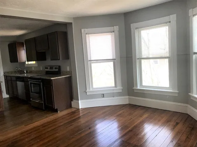 a kitchen with granite countertop wooden floors and sink