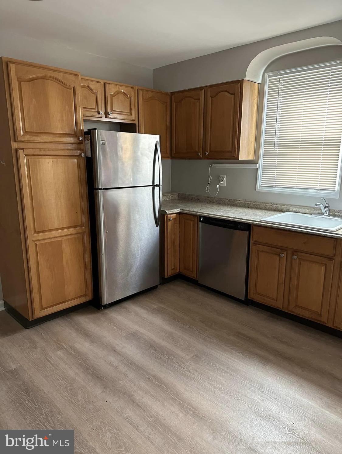 9904 Harford Road Baltimore, MD 21234 - Photo 4 of 15 a kitchen with stainless steel appliances granite countertop a refrigerator a sink and a granite counter tops