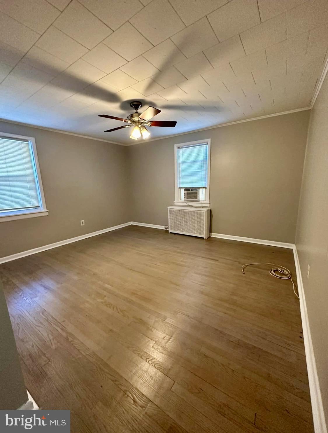 9904 Harford Road Baltimore, MD 21234 - Photo 7 of 15 an empty room with a ceiling fan and window