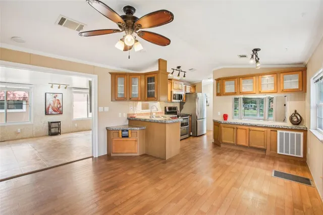 a kitchen with stainless steel appliances granite countertop a stove and a sink