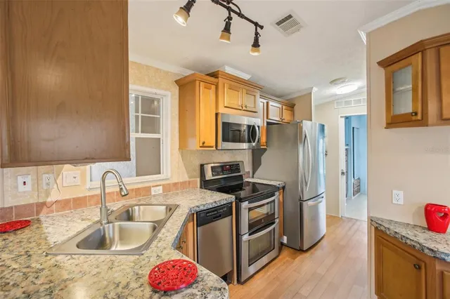 a kitchen with wooden cabinets and a stove top oven