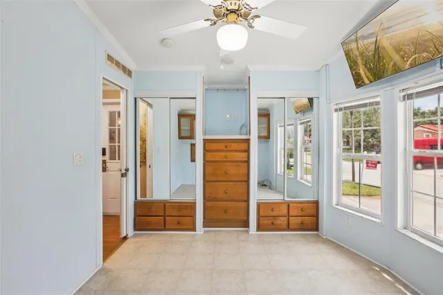 a view of a big room with wooden floor and windows