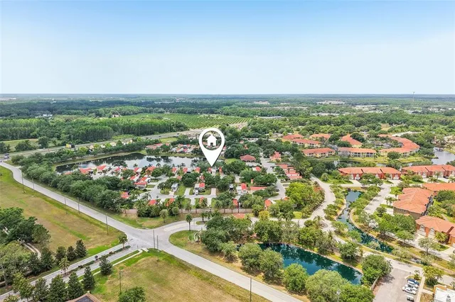 an aerial view of lake and residential houses with outdoor space