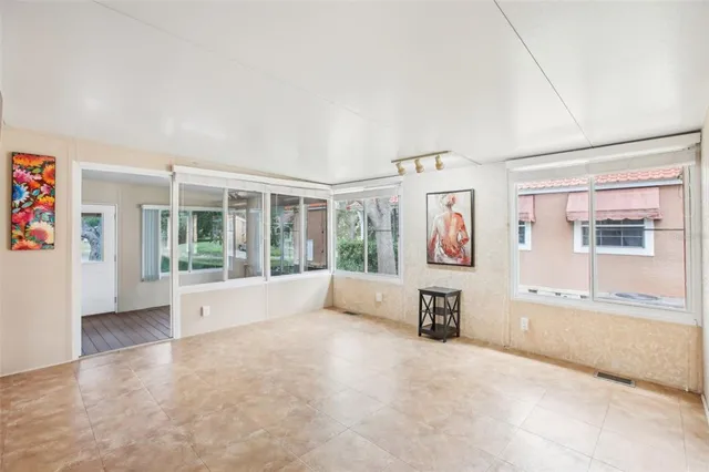 an empty room with a empty space and windows