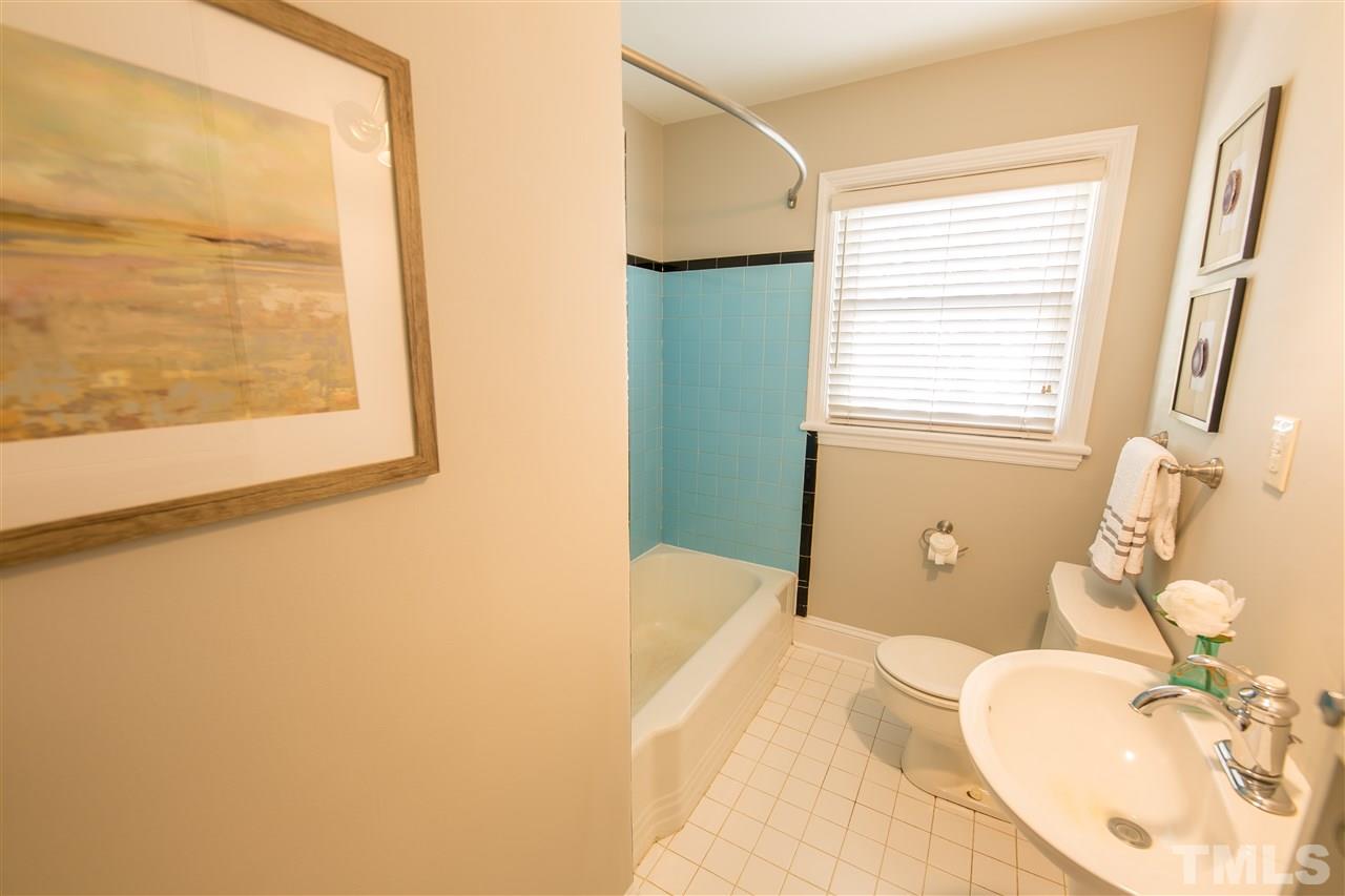 710 East Whitaker Mill Road Raleigh, NC 27608 - Photo 11 of 25 a bathroom with a tub sink and a mirror