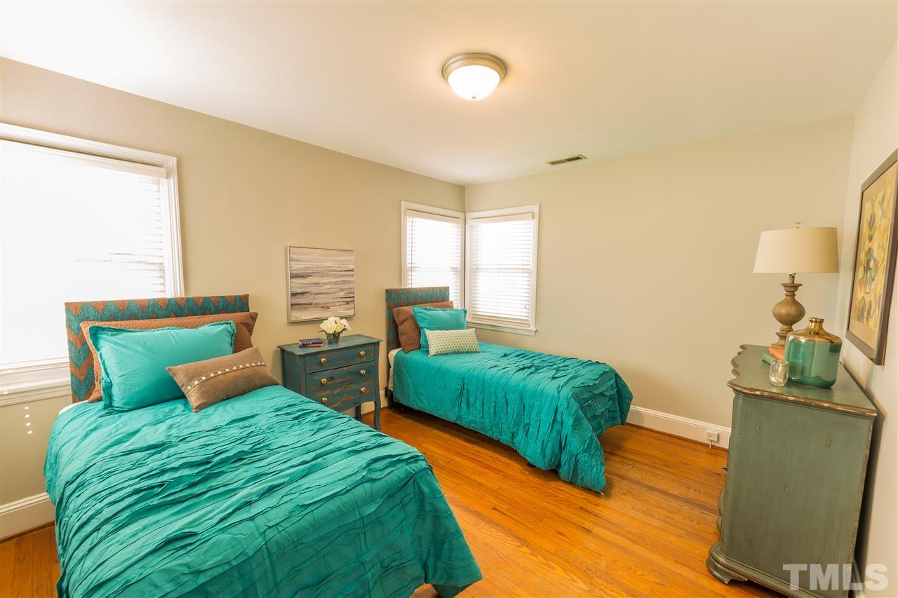 710 East Whitaker Mill Road Raleigh, NC 27608 - Photo 12 of 25 a bedroom with a bed and a dresser