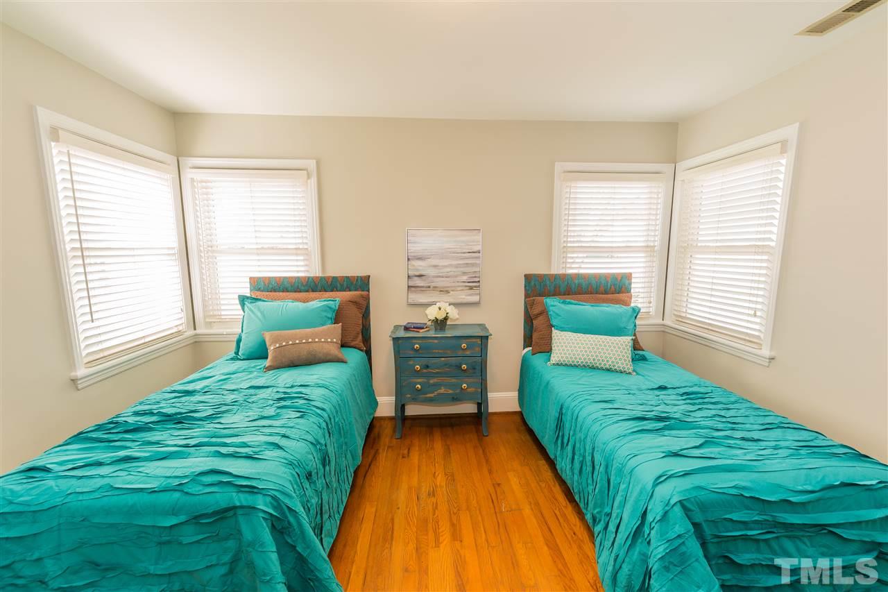 710 East Whitaker Mill Road Raleigh, NC 27608 - Photo 13 of 25 a spacious bedroom with a bed and a window
