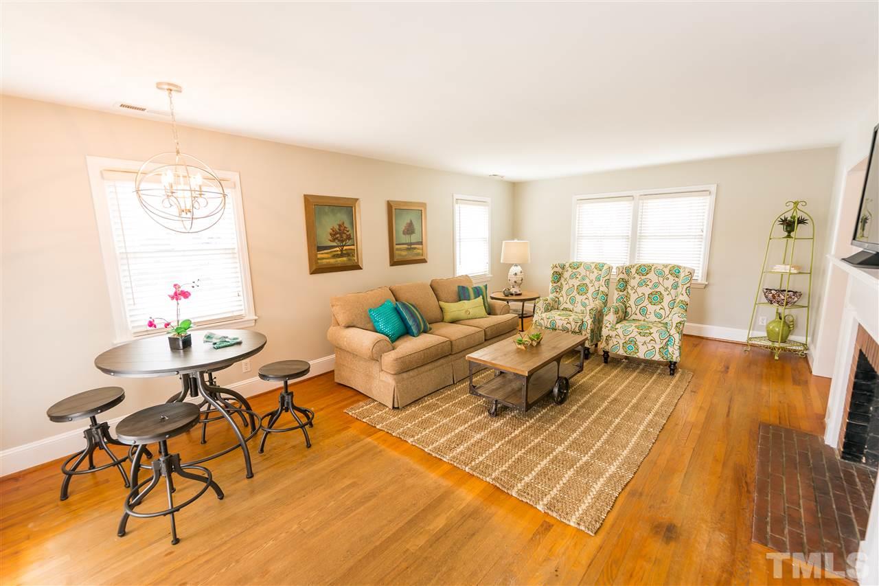 710 East Whitaker Mill Road Raleigh, NC 27608 - Photo 4 of 25 a living room with furniture and a wooden floor