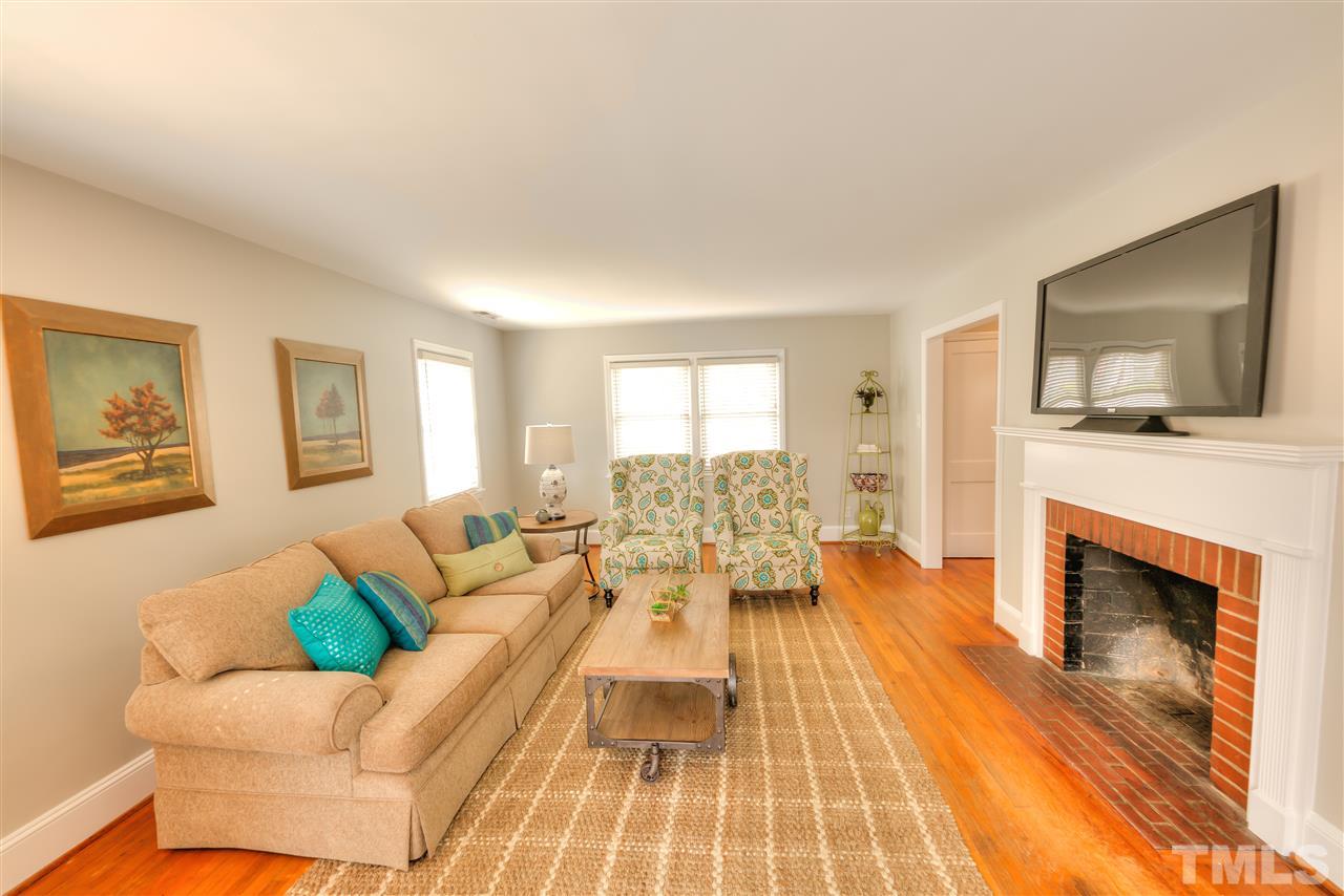 710 East Whitaker Mill Road Raleigh, NC 27608 - Photo 5 of 25 a living room with furniture and a fireplace