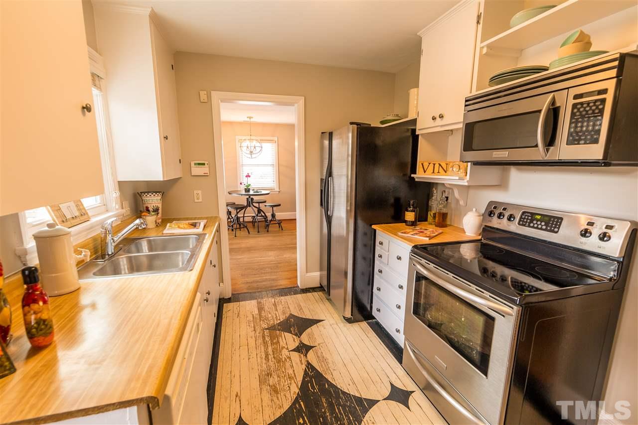 710 East Whitaker Mill Road Raleigh, NC 27608 - Photo 6 of 25 a kitchen with a stove and a refrigerator