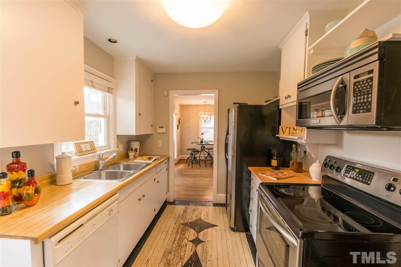710 East Whitaker Mill Road Raleigh, NC 27608 - Photo 7 of 25 a kitchen with a stove a refrigerator and a sink