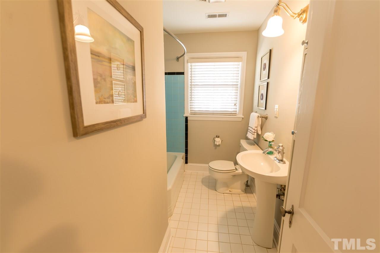 710 East Whitaker Mill Road Raleigh, NC 27608 - Photo 10 of 25 a bathroom with a sink and a mirror