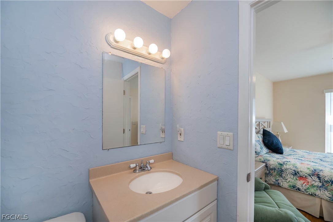 1100 Pondella Road, Unit 514 Cape Coral, FL 33909 - Photo 23 of 34 a en suite bathroom with a sink and a mirror