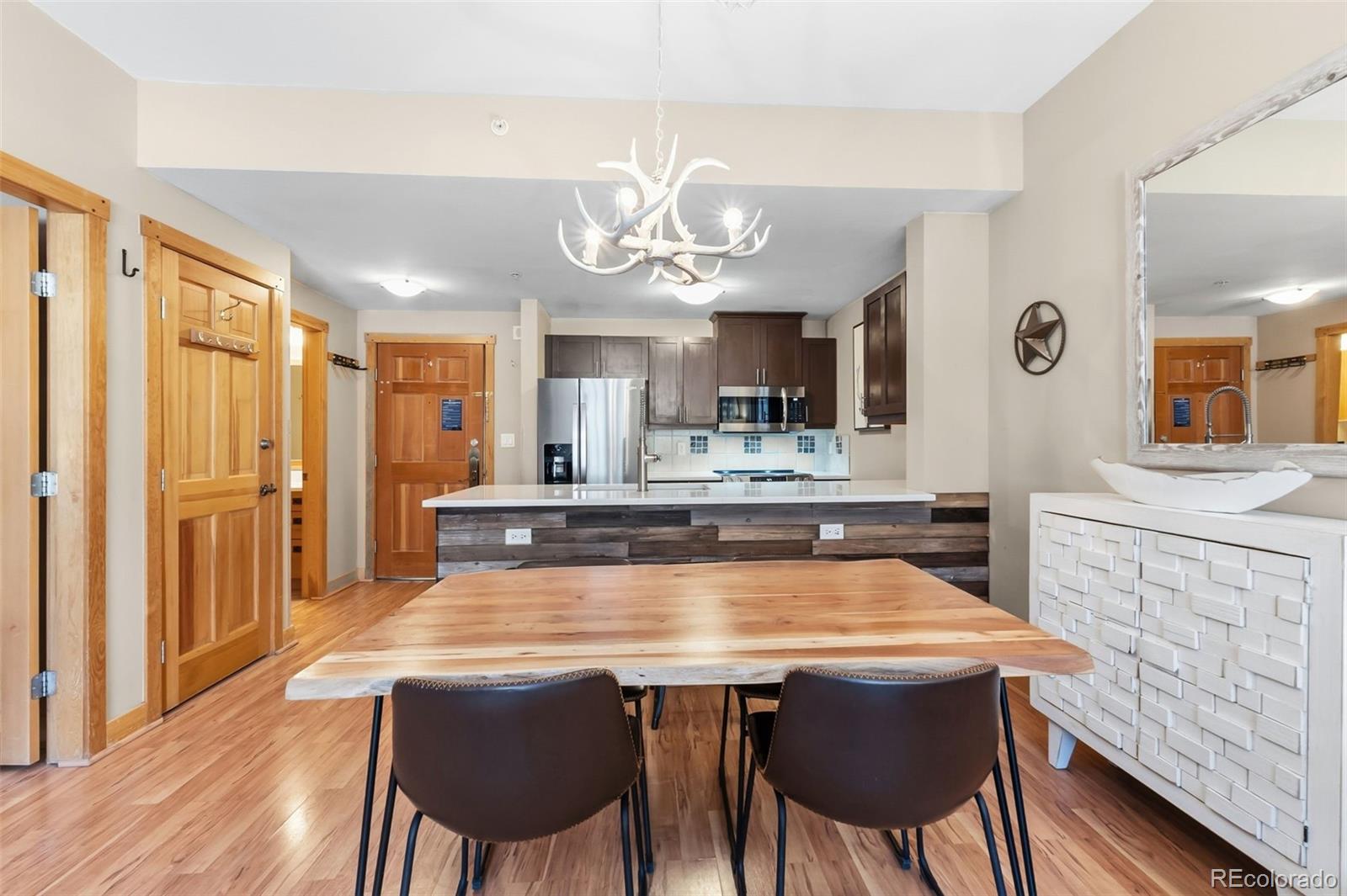 910 Copper Road, Unit 621 Frisco, CO 80443 - Photo 12 of 31 a view of a dining room with furniture and wooden floor