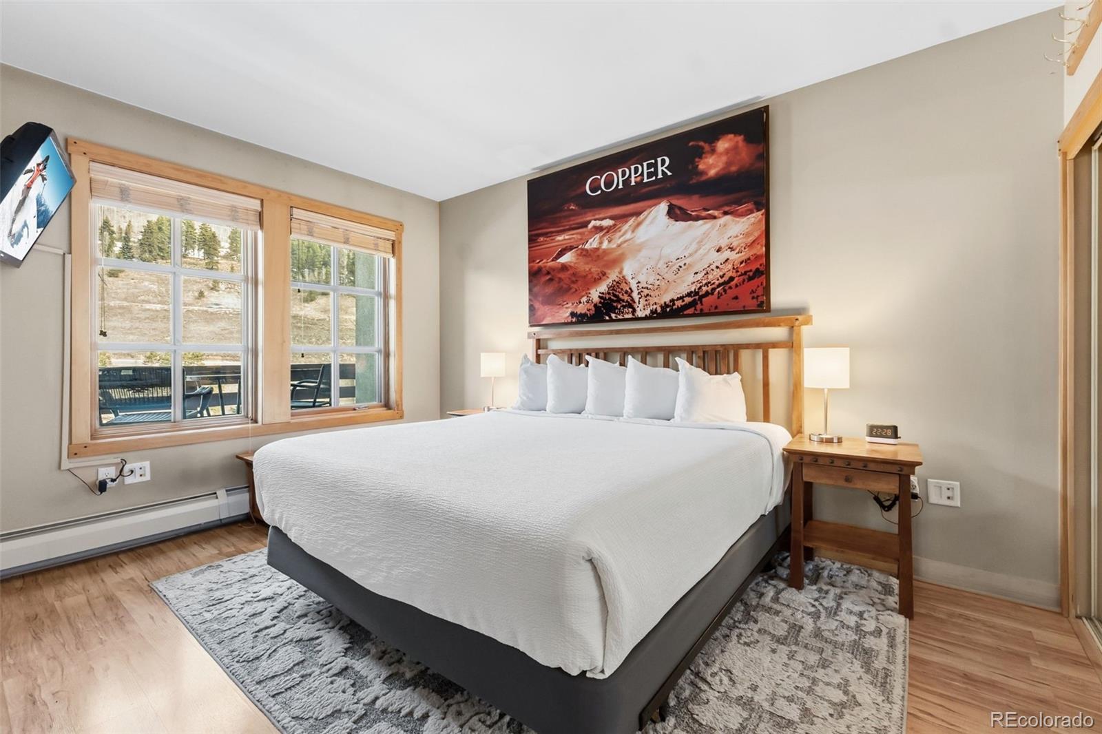 910 Copper Road, Unit 621 Frisco, CO 80443 - Photo 14 of 31 a bed sitting in a bedroom next to a window