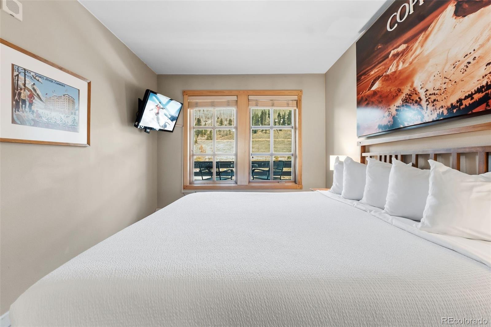 910 Copper Road, Unit 621 Frisco, CO 80443 - Photo 16 of 31 a bedroom with a large bed and a large window