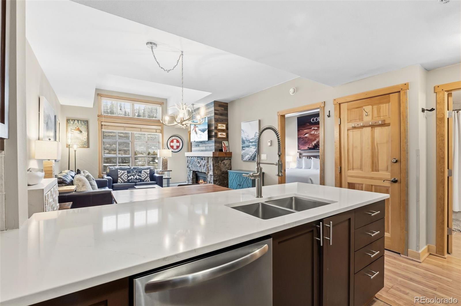 910 Copper Road, Unit 621 Frisco, CO 80443 - Photo 18 of 31 a view of a kitchen island a sink and living room