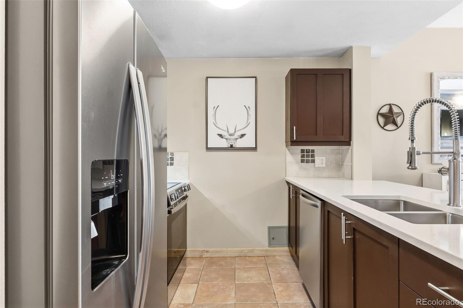 910 Copper Road, Unit 621 Frisco, CO 80443 - Photo 3 of 31 a kitchen with stainless steel appliances granite countertop a refrigerator and a sink