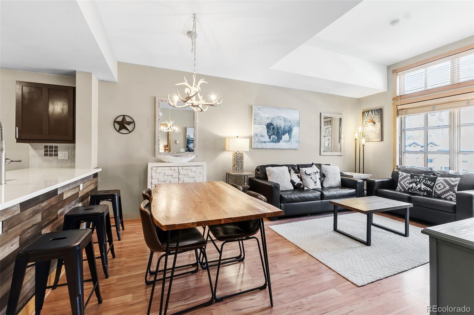 910 Copper Road, Unit 621 Frisco, CO 80443 - Photo 6 of 31 a living room with furniture a chandelier and a flat screen tv