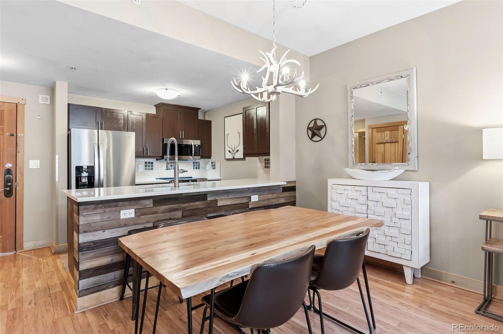 910 Copper Road, Unit 621 Frisco, CO 80443 - Photo 9 of 31 a dining table with chairs and kitchen view