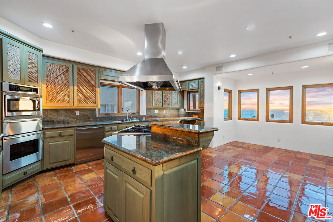 7047 Vista Del Mar Lane Playa del Rey, CA 90293 - Photo 13 of 75 a kitchen with stainless steel appliances granite countertop a sink stove and cabinets